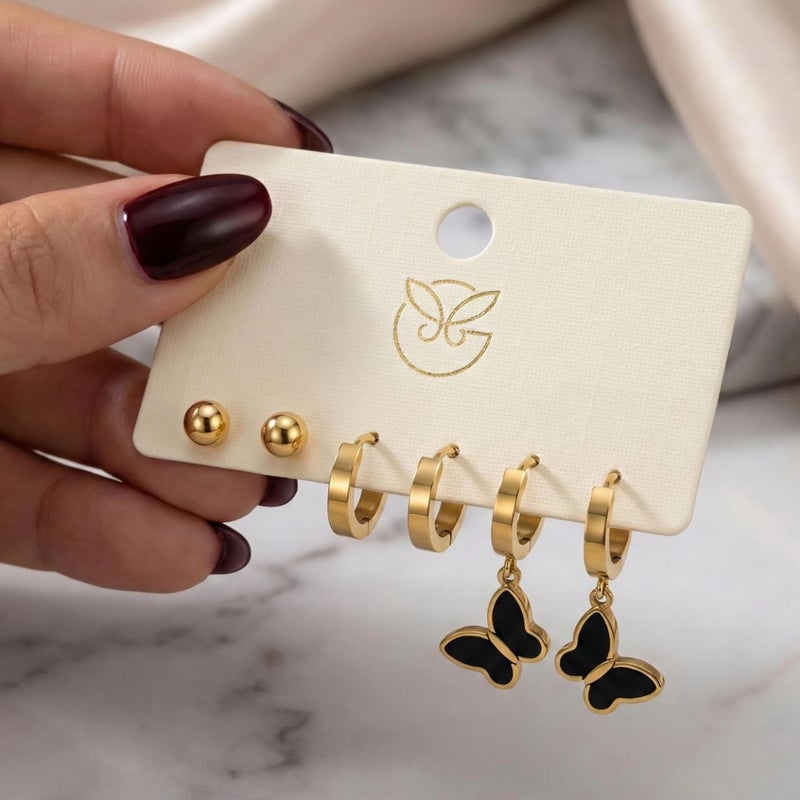 طقم ٣ أزواج حلقان ذهبي مميز: بريمة الكرة الذهبية، حلقات سادة لامعة، فراشة سوداء متدلية فاخرة. من الستانلس ستيل المقاوم للصدأ، لإطلالة لامعة وعصرية. - Image 4